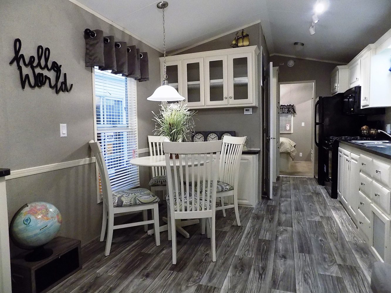 Interior—Summit-355FL-with-Front-Porch—White-Cabinets-&-Gray-Plank-Flooring